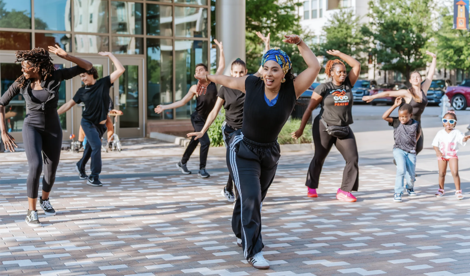 a group of dancers in casual clothing celebrating African dance