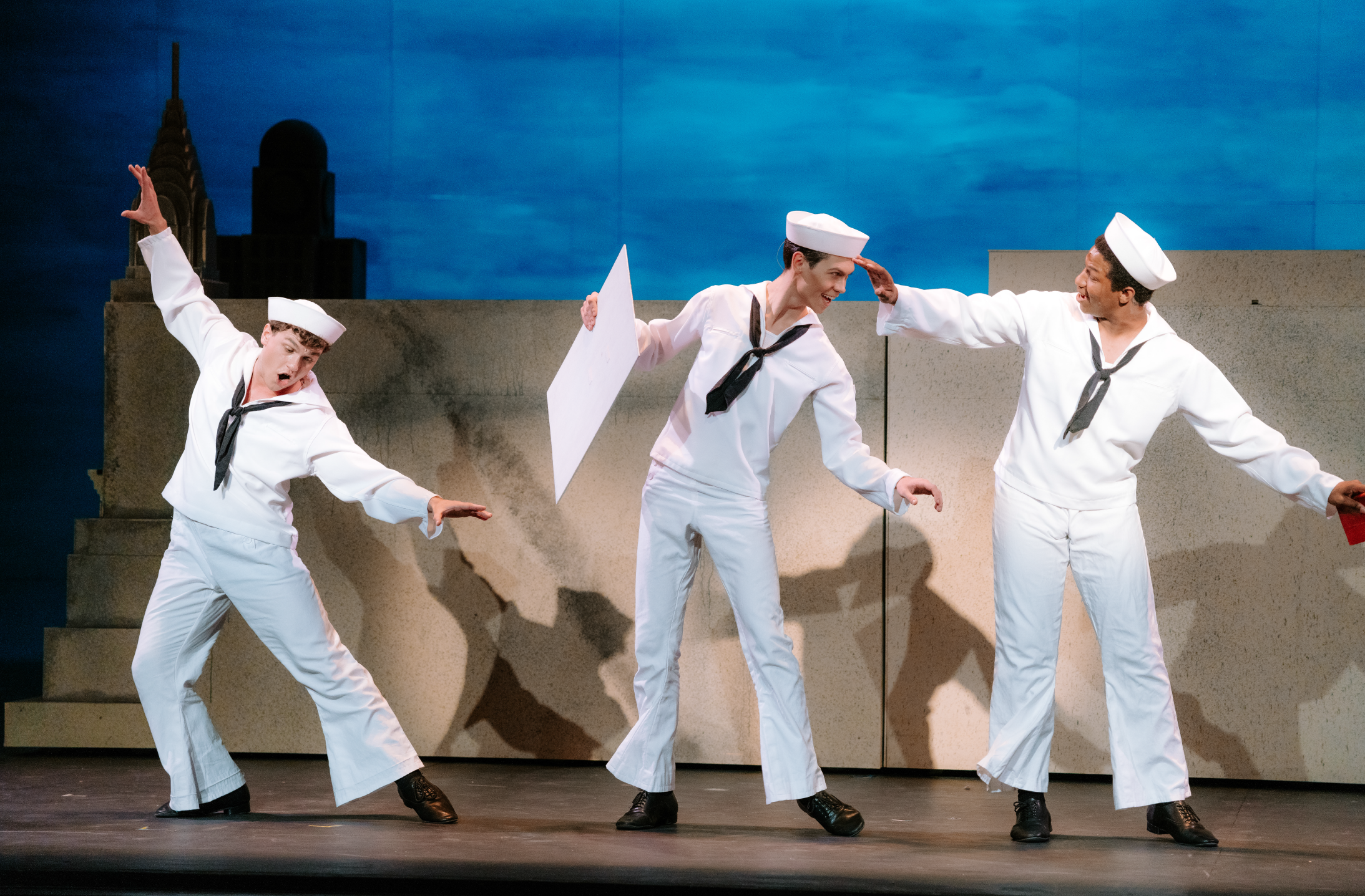 Three actors dancing in sailor costume