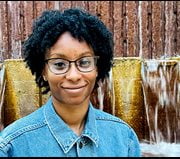 Headshot of young playwright in front of fountain