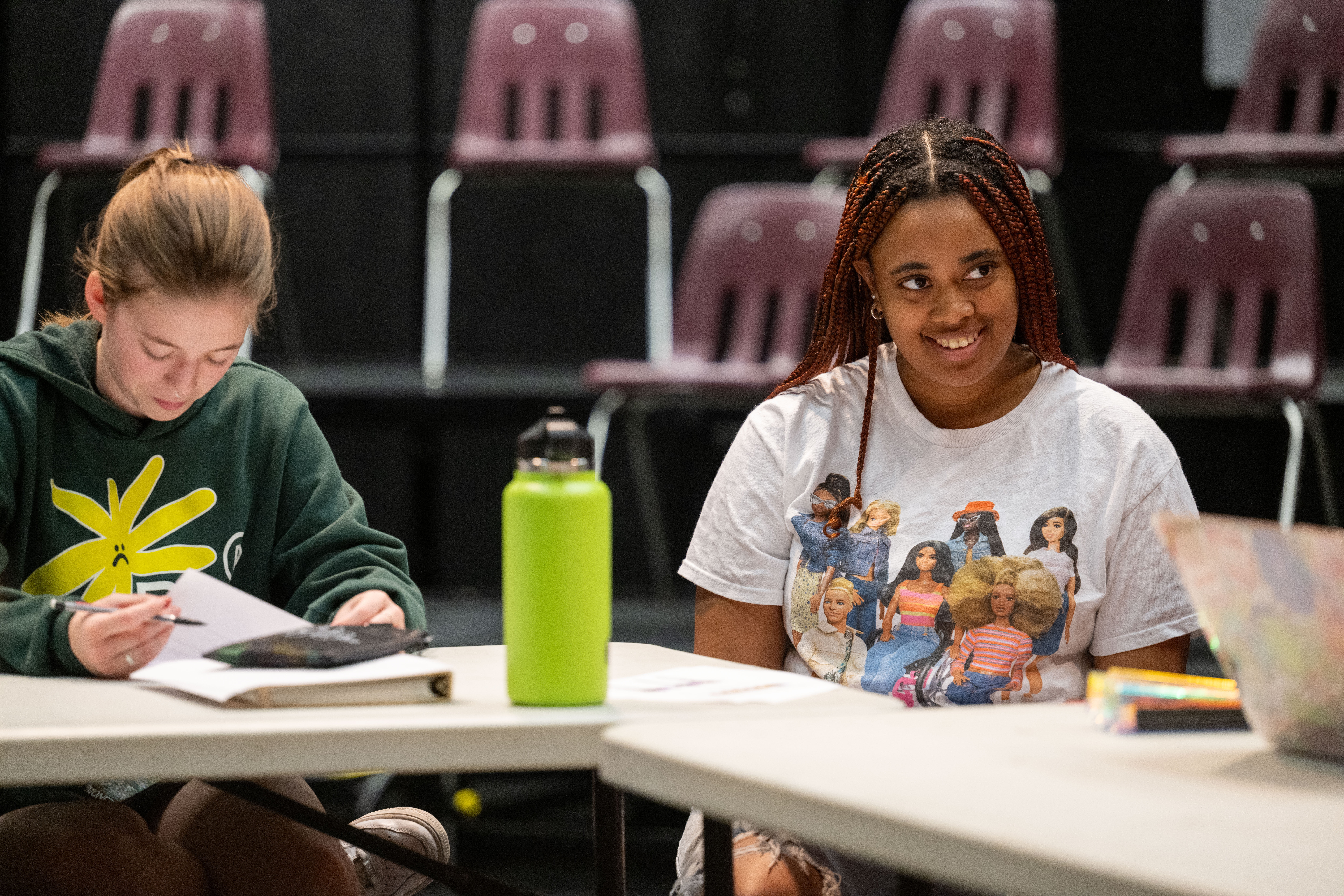 Two Students at a Table Smiling