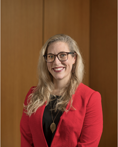 Smiling woman in red blazer