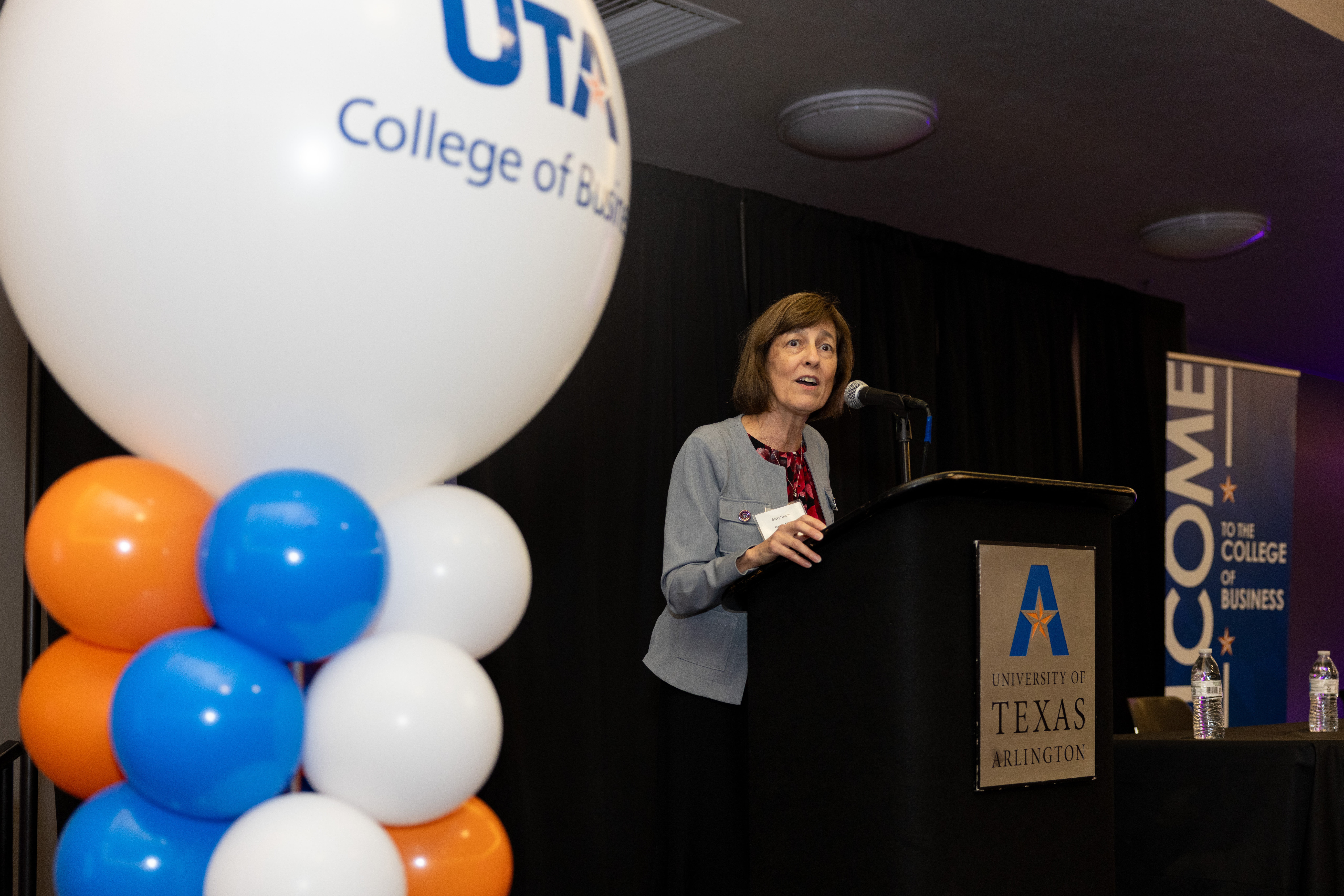 Rebecca Neilson, University of Texas college of Business Assistant Dean, speaks at a podium during the Admitted Graduate Students event August 29, 2024. (Photo by Jalen Larry) 