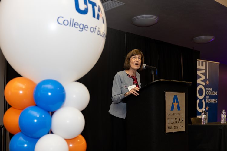 Rebecca Neilson, University of Texas college of Business Assistant Dean, speaks at a podium during the Admitted Graduate Students event August 29, 2024. (Photo by Jalen Larry)