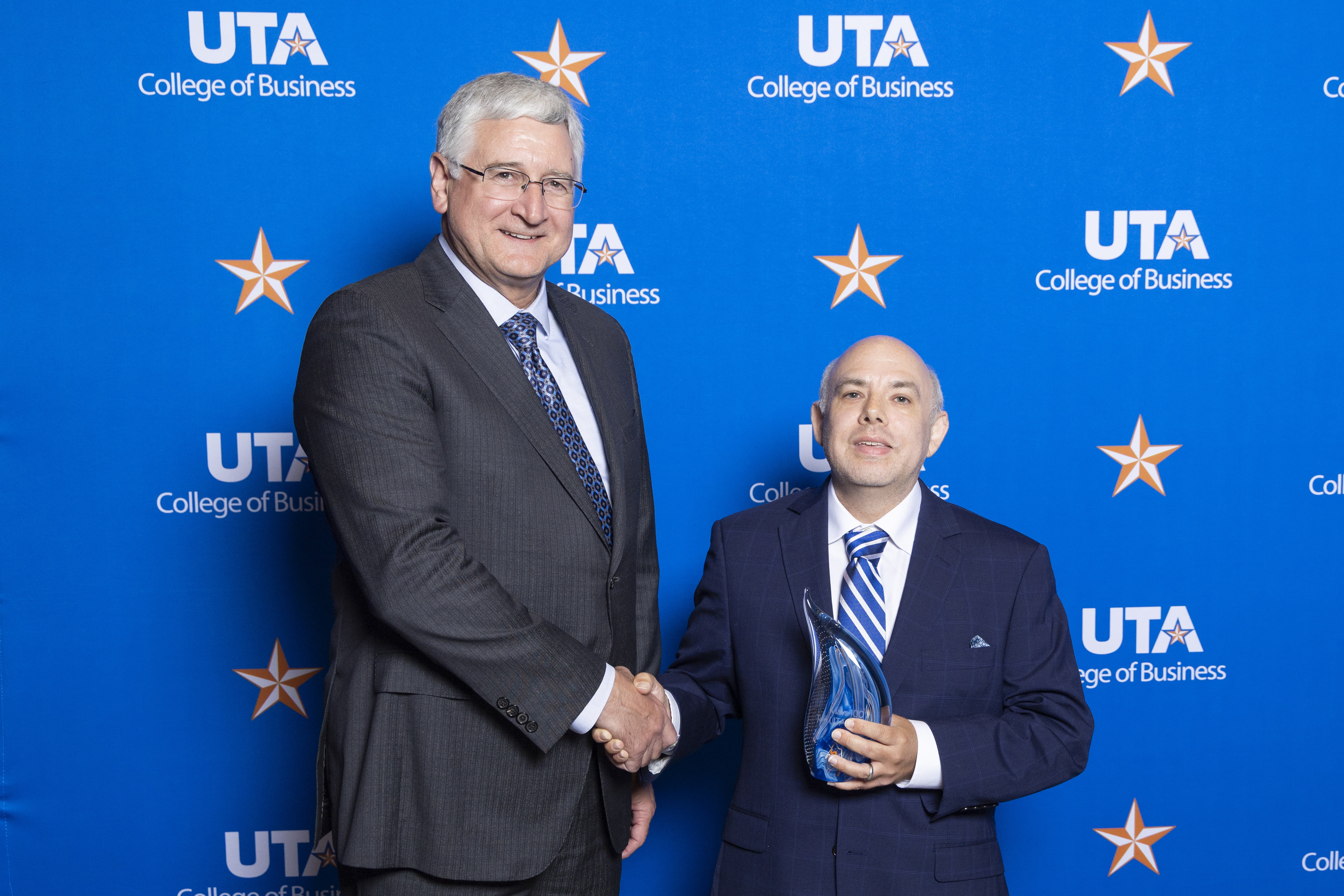 Greg Frazier shakes the hand of Richard Ashton, President of AMD Development, LLC. 