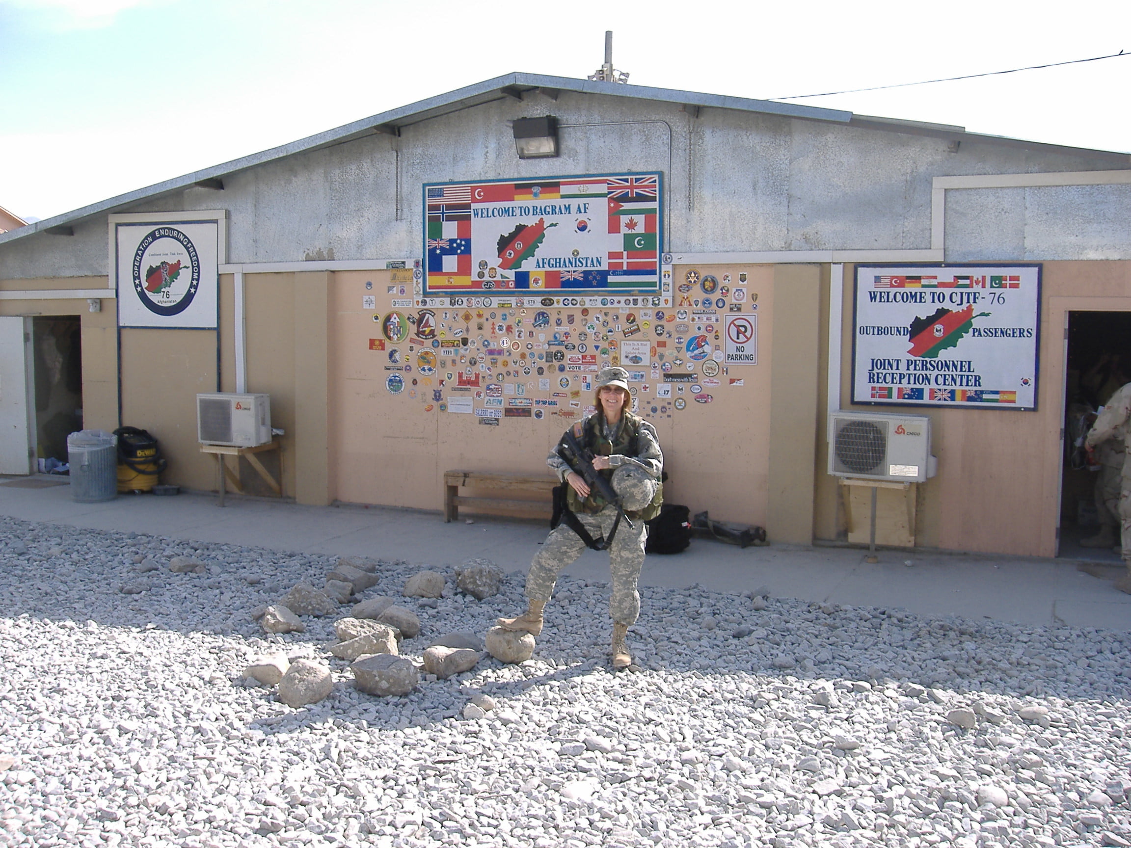 Retired U.S. Army Reserve Col. Rebecca Neilson, 321st Civil Affairs Brigade, Deputy Brigade Commander poses for a photo while waiting for transportation in front of a passenger terminal at Bagram Air Base, Afghanistan. (Courtesy Photo)