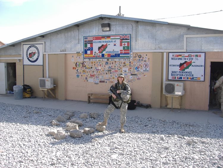 Retired U.S. Army Reserve Col. Rebecca Neilson, 321st Civil Affairs Brigade, Deputy Brigade Commander poses for a photo while waiting for transportation in front of a passenger terminal at Bagram Air Base, Afghanistan. (Courtesy Photo)