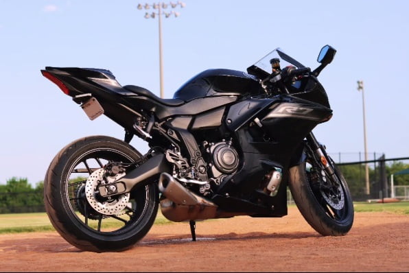 Picture of Harold Hankerson's black motor bike outside.