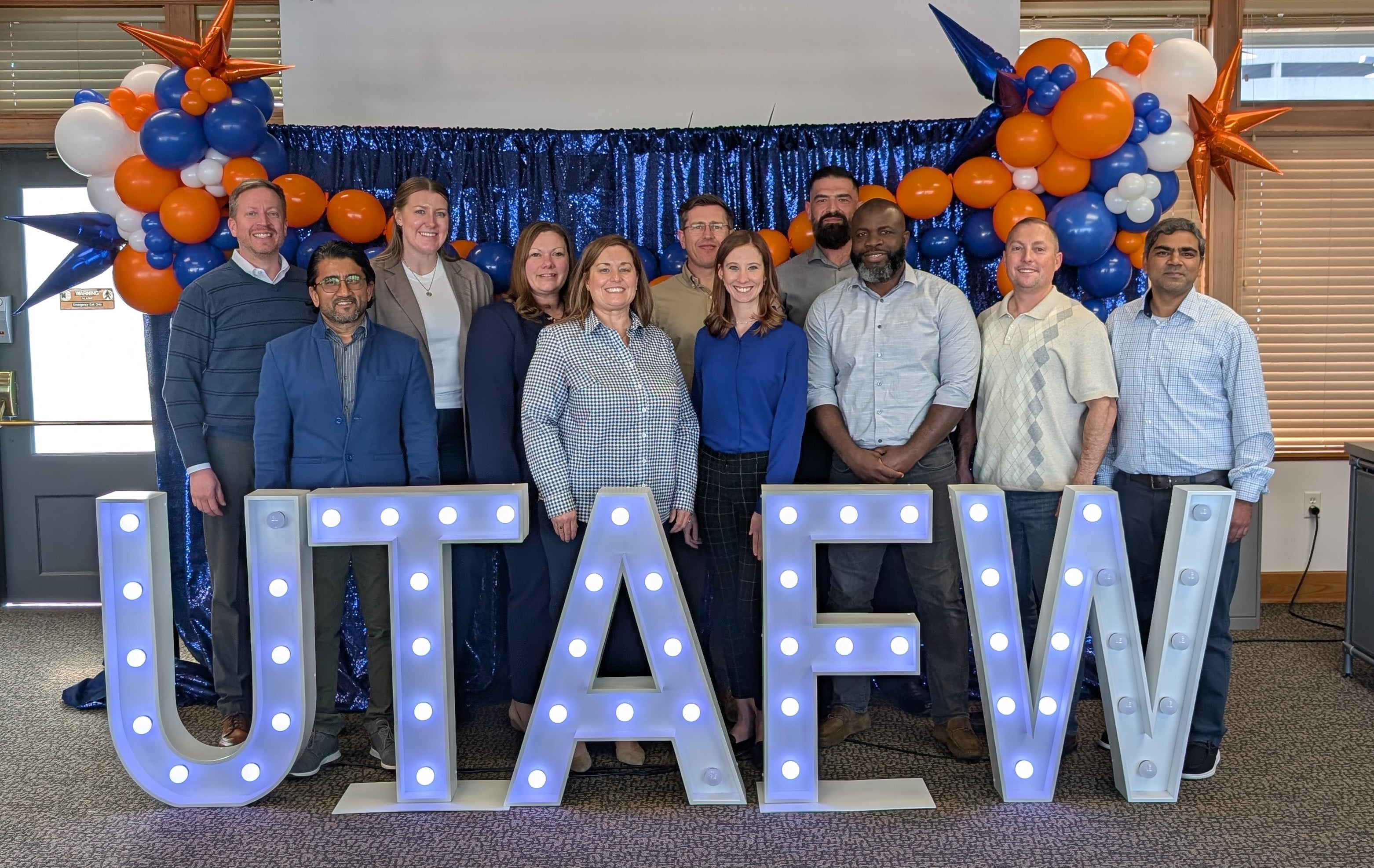 A cohort of the UTA College of Business Executive MBA program poses with a UTA Fort Worth sign. (Courtesy Photo)