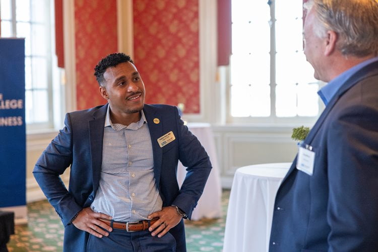 Hakim Sims, the Executive MBA Program Director at the UTA College of Business in Fort Worth, speaks with an attendee of the UTA College of Business Executive MBA Exec Connect event in Fort Worth. (Photo by Jalen Larry)