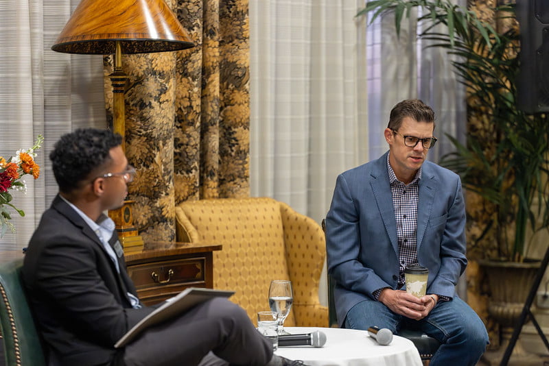 Hakim Sims sits across from PRAX co-founder Andrew Geesbreght during their conversation. Photo by Jalen Larry.