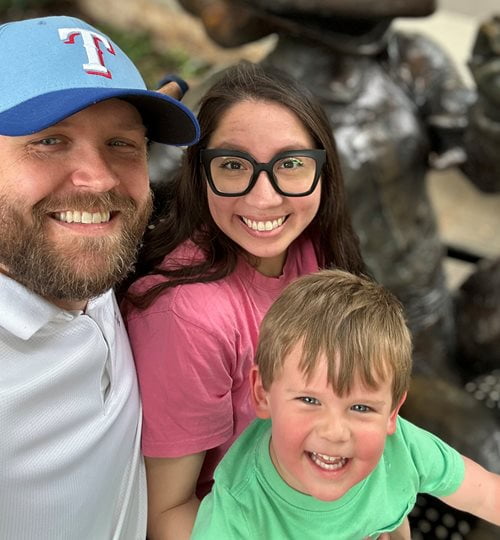 Scott Elbert, wife and son Henry pose for a selfie with a sculpture in the background.