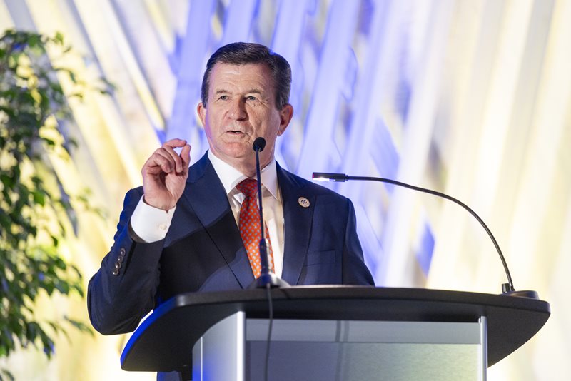 Dean Harry Dombroski speaks behind a podium.