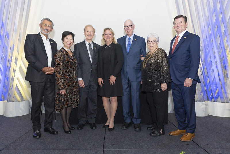 From left to right: Sam Mahrouq, Vicky Teherani, John Merrill, Jackie Fouse, John and Judy Goolsby and Dean Harry Dombroski pose for a photo on stage.