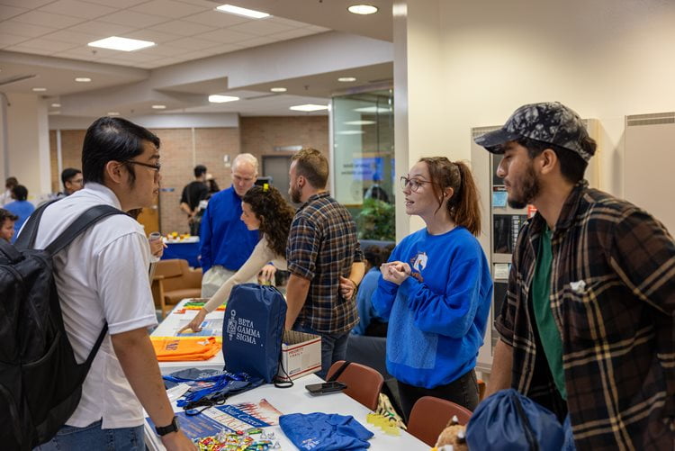 A student meets with members of Beta Gamma Sigma, the international business honor society during the UTA College of Business Student Organization Fair on September 11, 2024. (Photo by Jalen Larry)