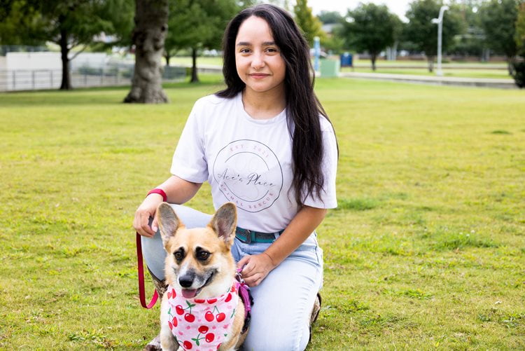 Ace Swenson poses for a photo with a rescue corgi mix, Sadie.
