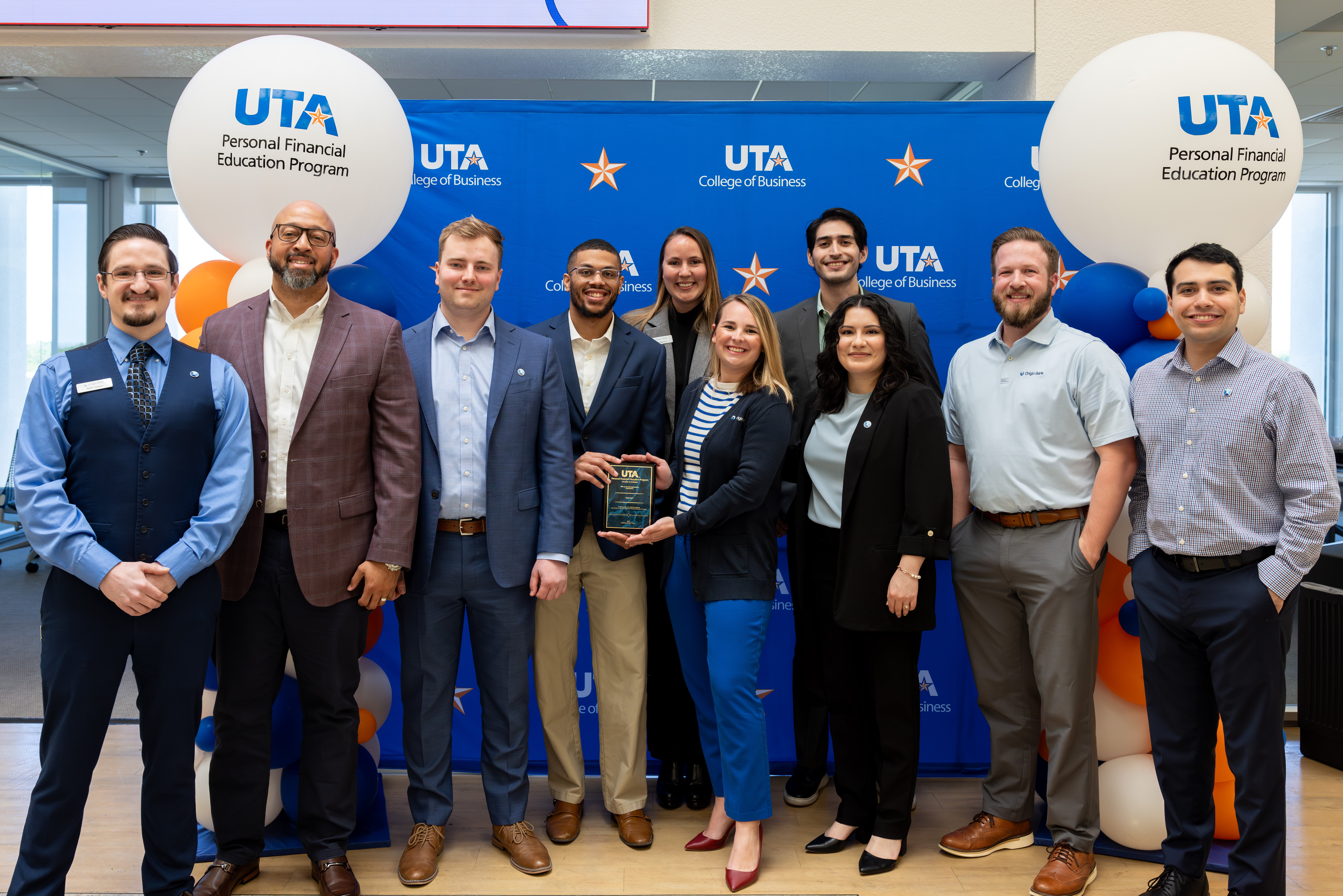 Group stands together for photo after event