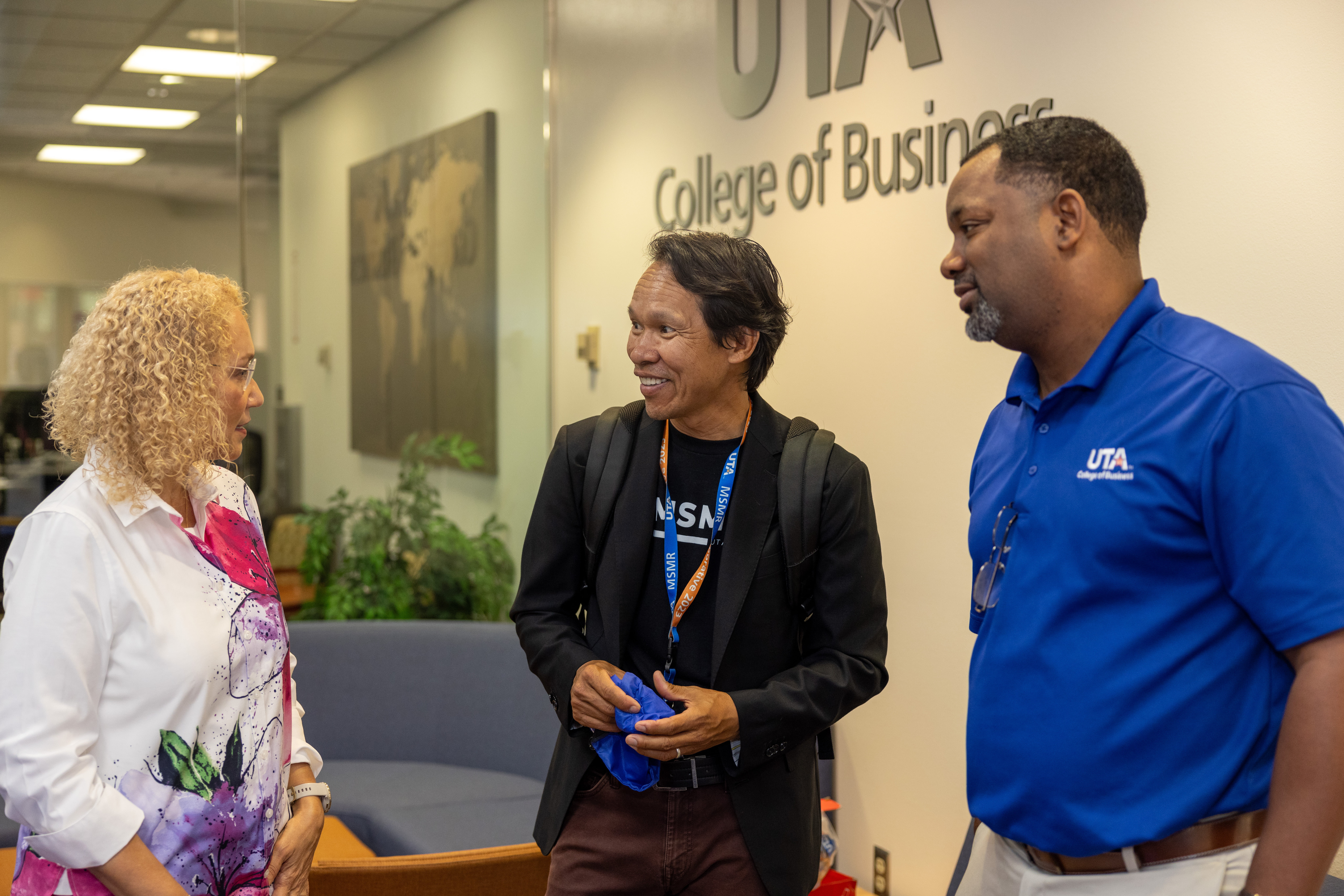 Dr. Michaela Mora, Assistant Professor of Practice in Marketing (Left), Dr. Chien Le, Clinical Associate Professor of Marketing (Center), and Dr. Elten Briggs UTA College of Business Marketing Department Chair (Right) speak with one another at an All Majors Fair at the UTA College of Business on August 21, 2024. (Photo by Jalen Larry) 