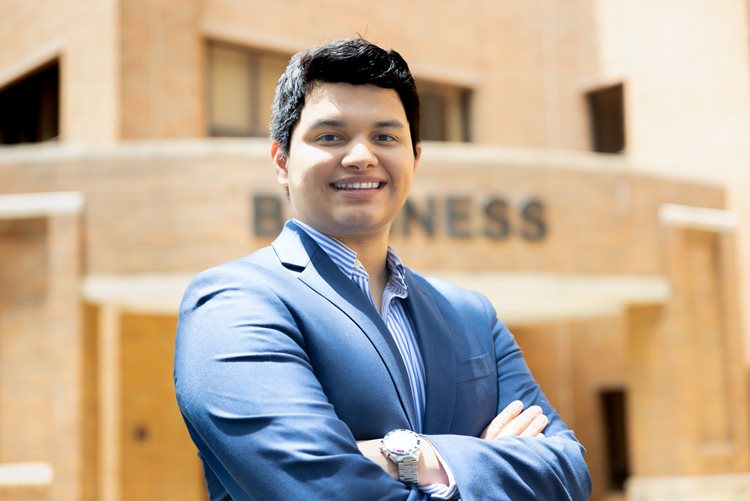 Oswaldo Ortiz Jr. (Oswald) stands in front of the College of Business at the University of Texas at Arlington on May 31, 2024.
