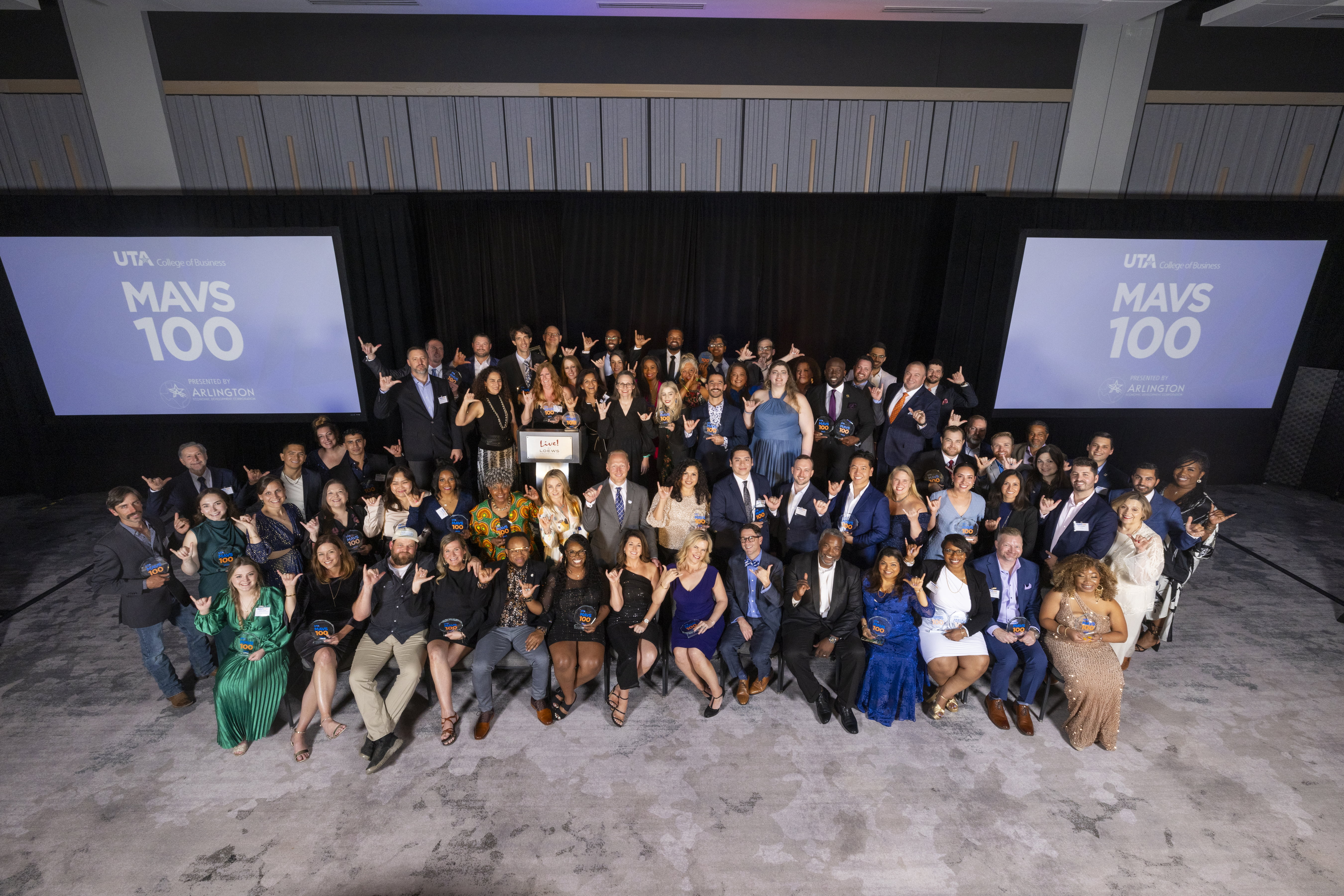 Awardees of the MAVS100 top 100 fastest growing UTA alumni led businesses pose for a photo at Live! By Loews in Arlington, Texas on May 3, 2023.