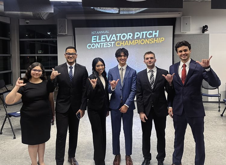 Participants of the Maverick Networking Night Elevator Pitch Competition pose while showing a “Mav Up!” hand sign. (Courtesy Photo)