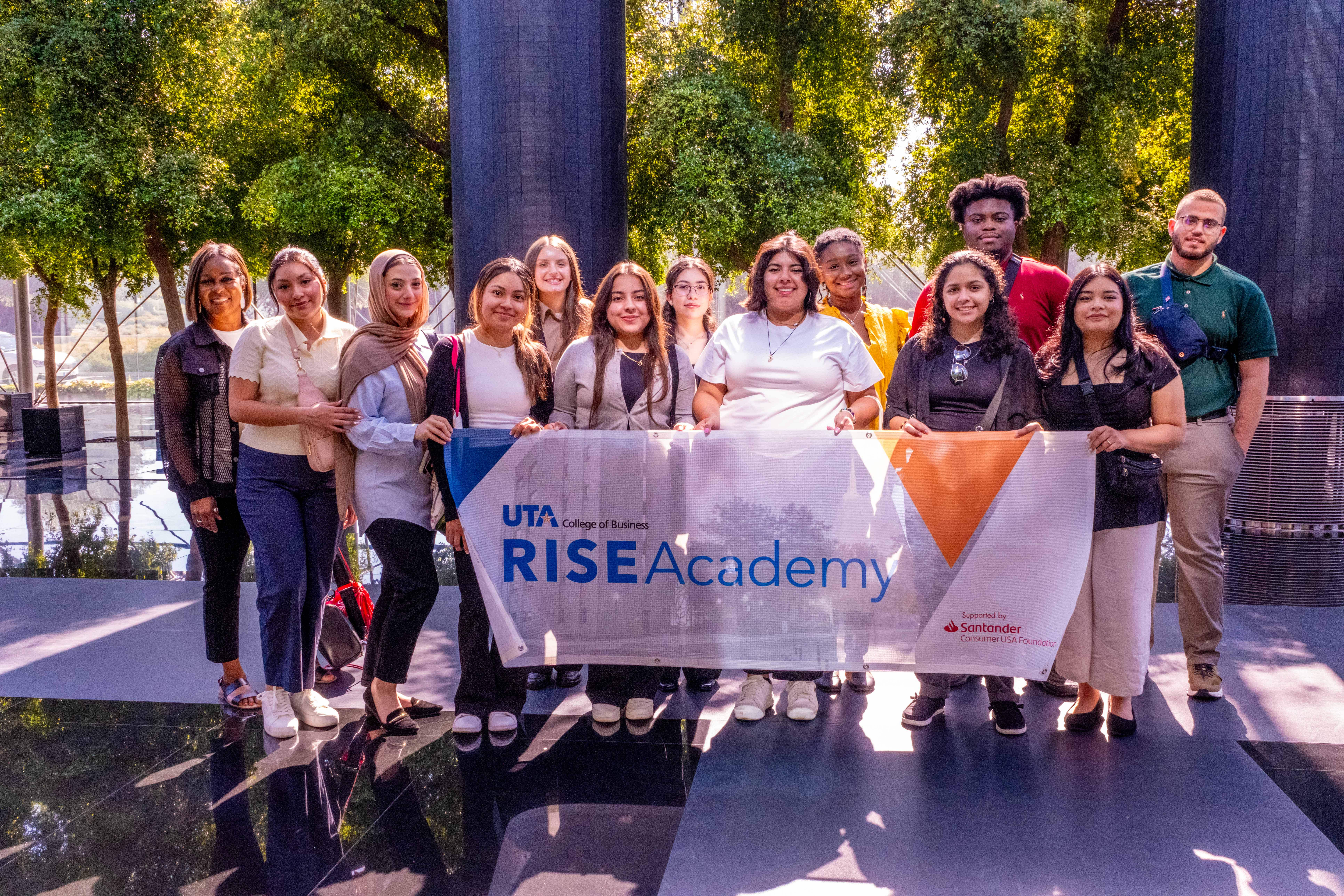 RISE Academy Students hold a banner representing their Academy at the Santander Group Financial City in Madrid, Spain. (Photo by Jhonniece Meeks) 
