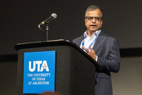 Information Systems chair Radha Mahapatra speaks behind a podium at the Business Analytics Symposium.
