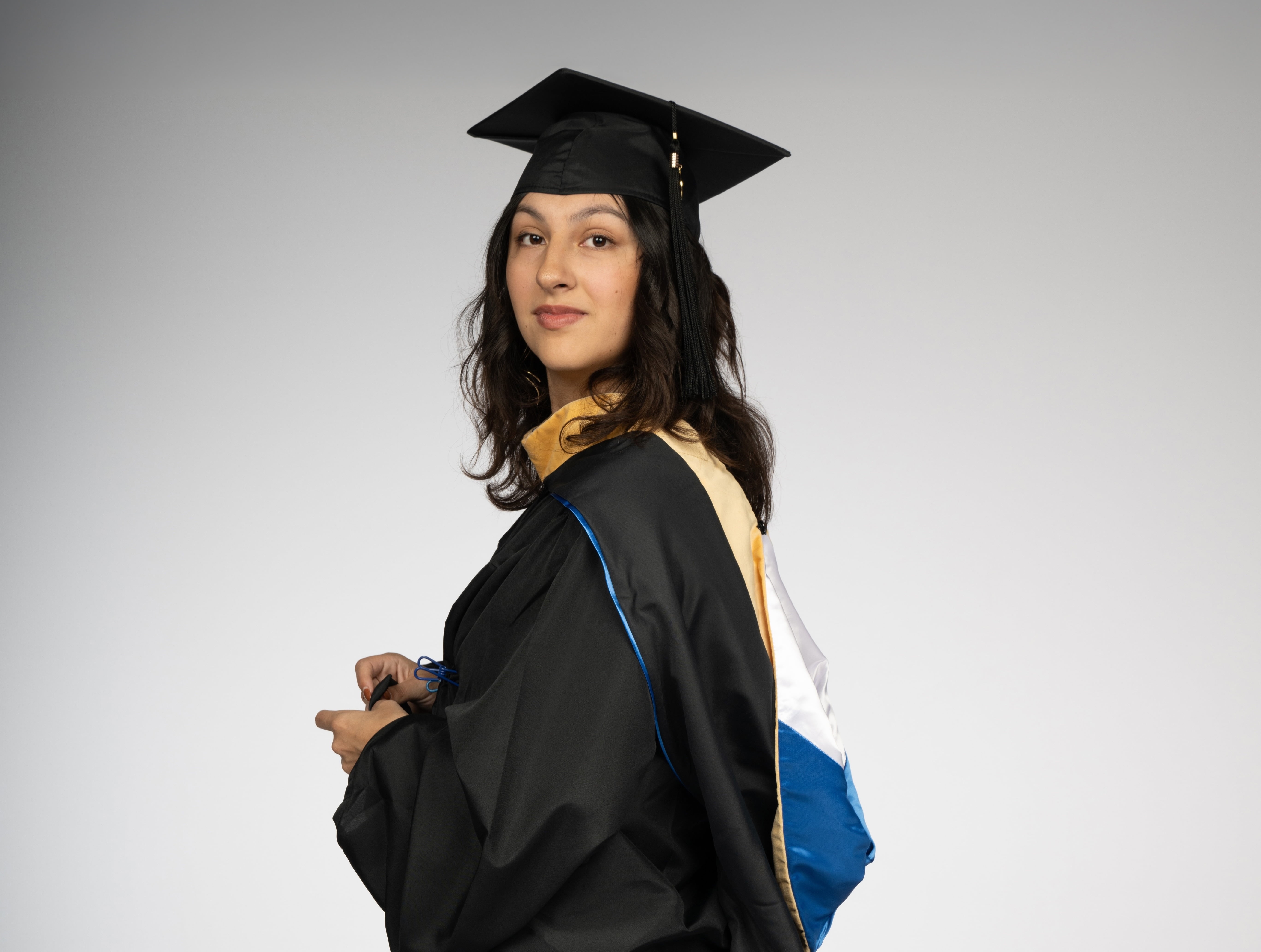 Headshot photo of student in graduate regalia