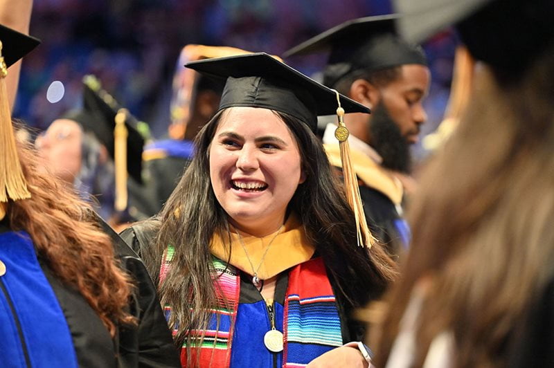 student in commencement regalia