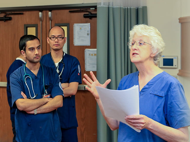 Nurse explaining a process to male and female nurses