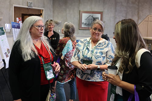Dr. Elizabeth Merwin speaking with guests at RNO Conference.