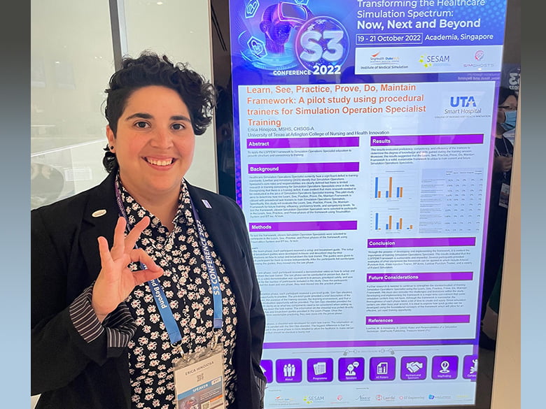 Erica Hinojosa with poster presentation, hand gester is "a-okay"