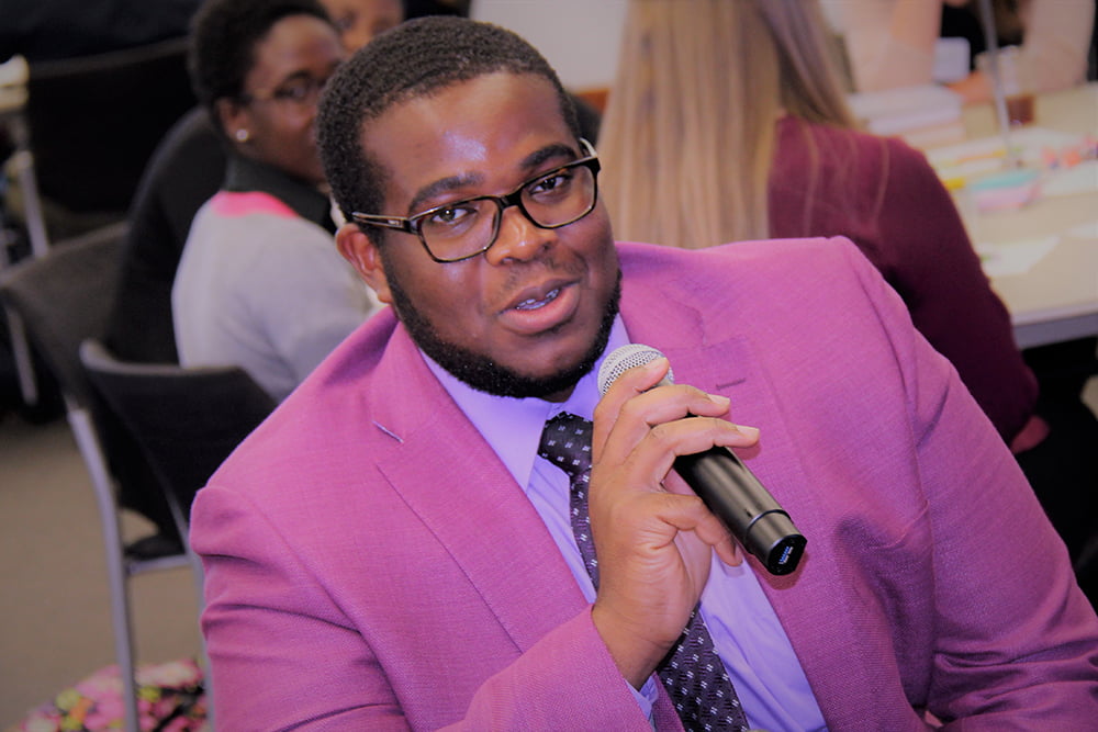 PhD Nursing Student speaking holding microphone