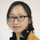 Portrait of Xiangli Gu with a grey background