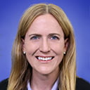 Portrait of Tiffany Kindratt with a blue background
