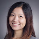 Portrait of Yue Liao with a gray background