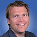 Portrait of Mike Nelson with a blue background