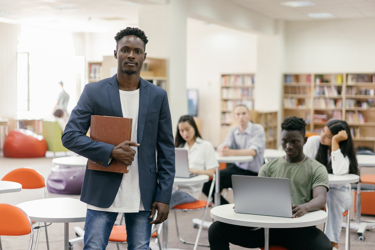 Man stands inside classroom