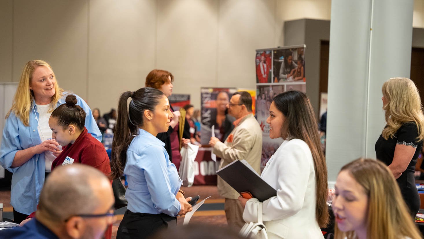 A UTA education student talks with a potential employer at the 2022 Education Career Day, a job hiring fair. 