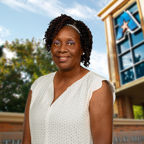 Headshot of University of Texas at Arlington employee Deborah Williams. The background shows a UTA campus sign.
