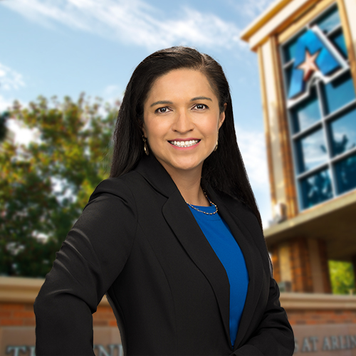 Headshot of University of Texas at Arlington employee Maria Delgado. The background shows a UTA campus sign.