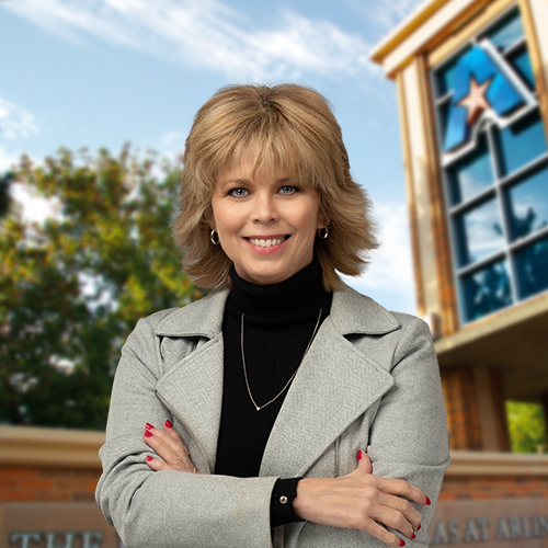 Headshot of University of Texas at Arlington employee Brenda Miller. The background shows a UTA campus sign.