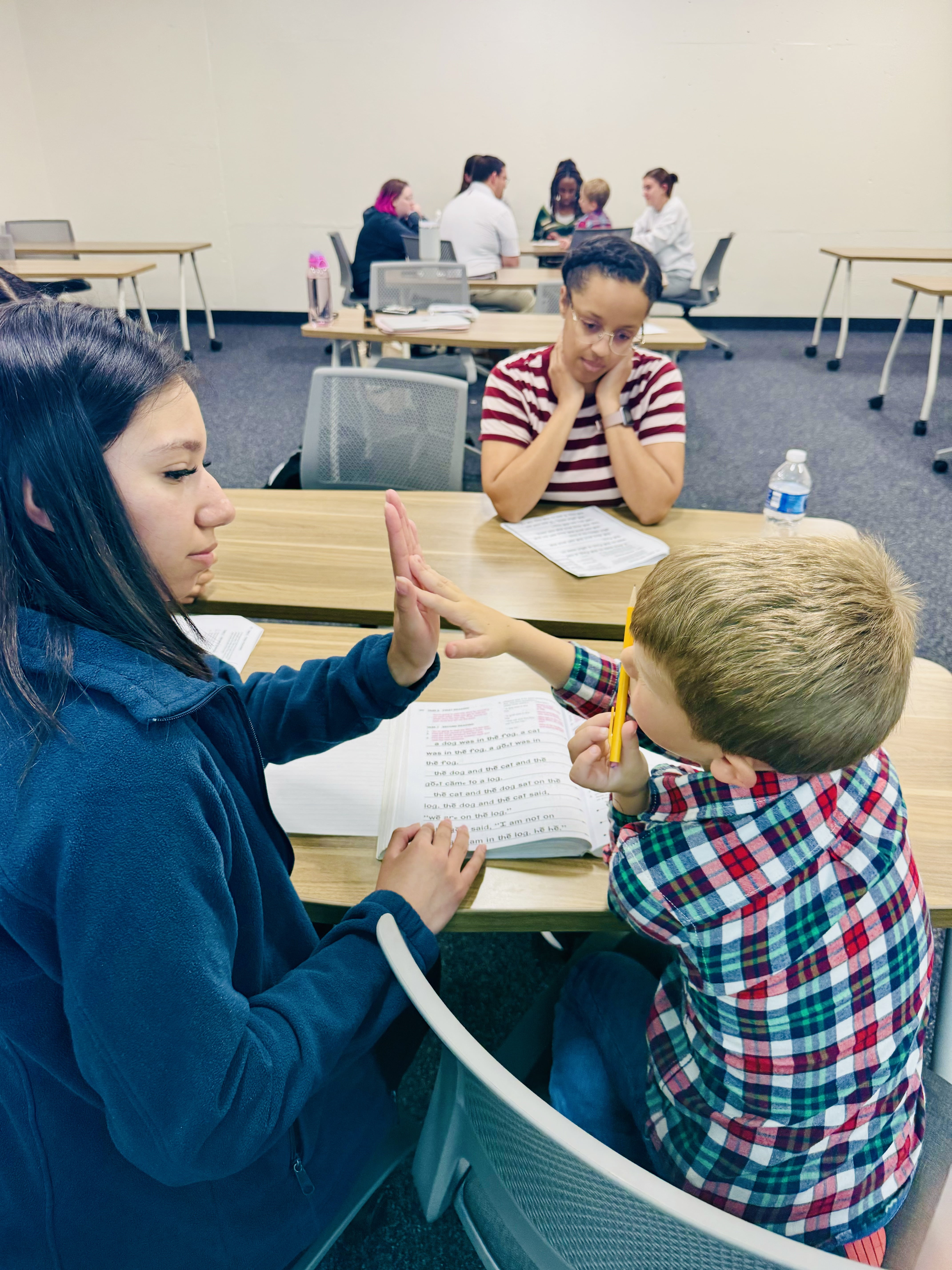 A U T A student gives 5-year-old Jack a high five. 