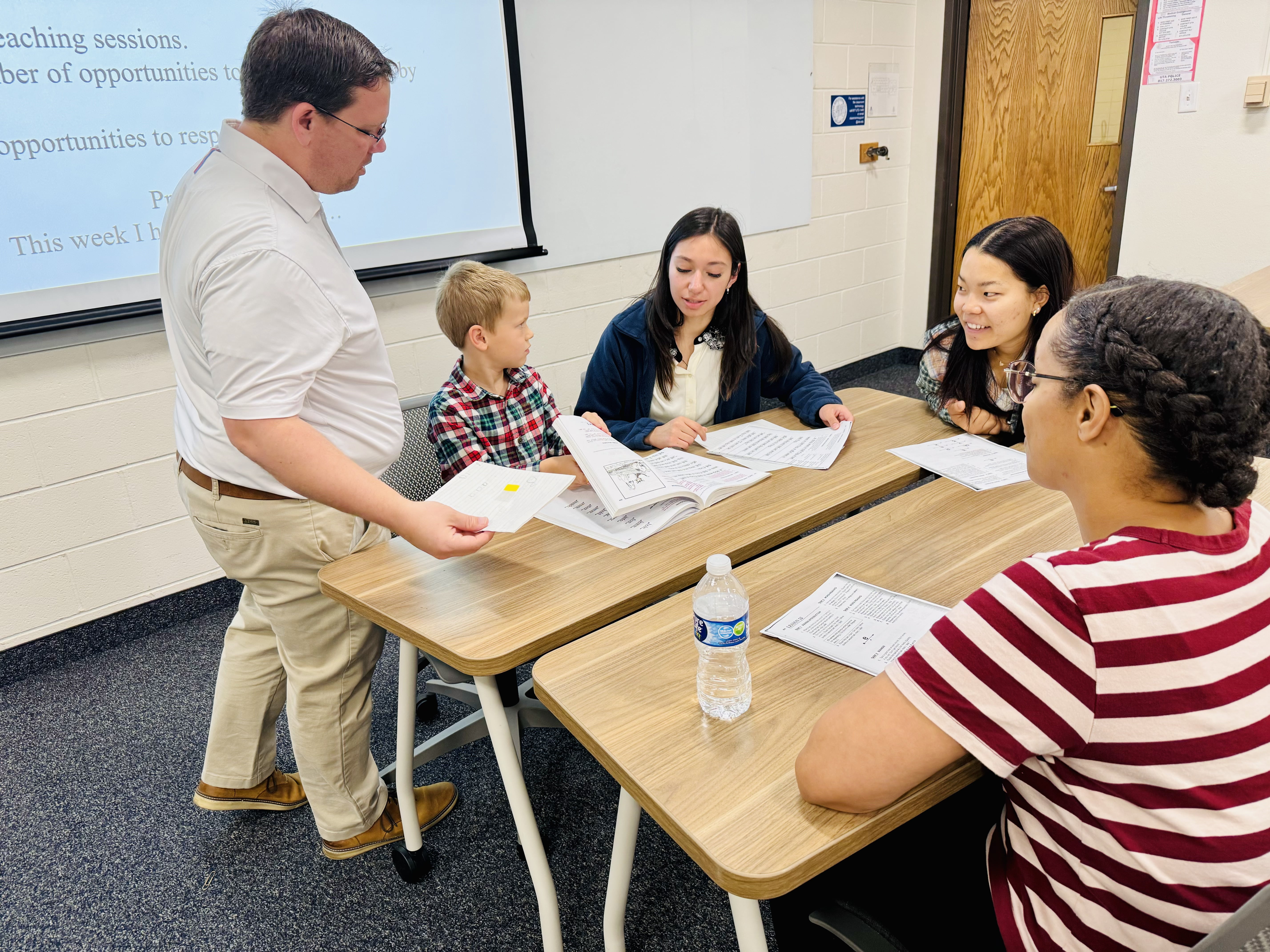 Dr. Romig talking to a group of students in his class. 