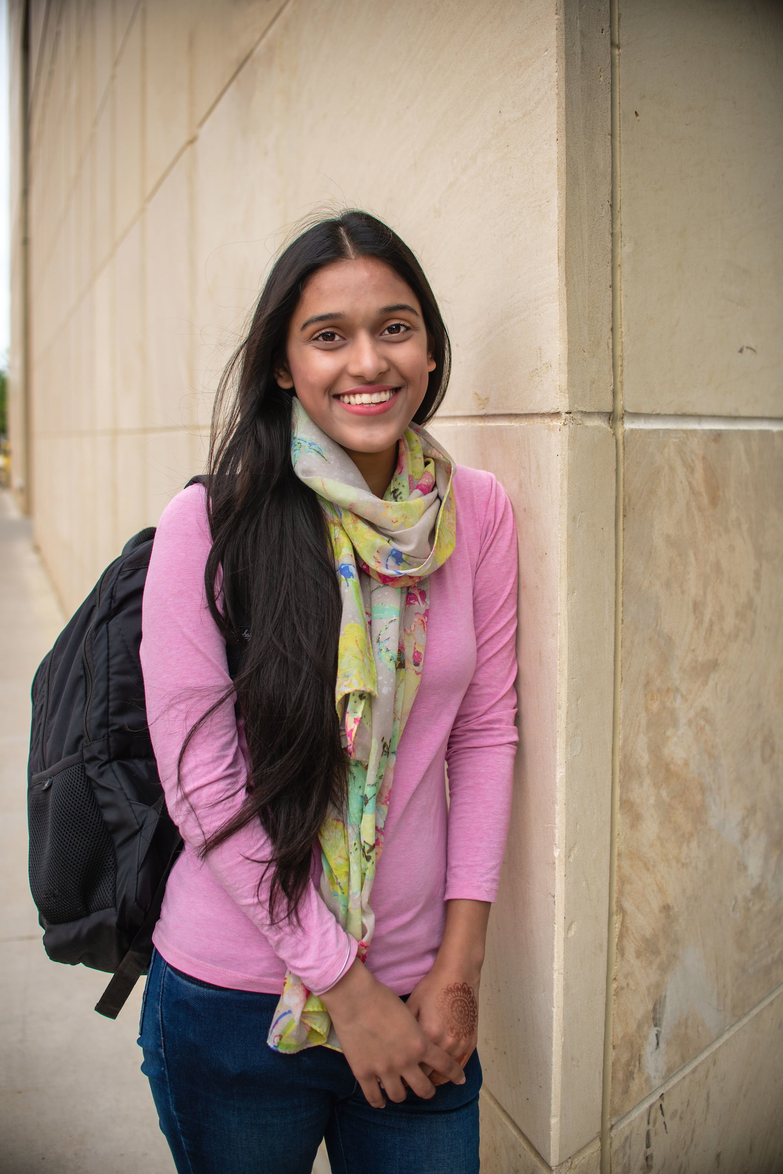 A University of Texas at Arlington student wearing a backpack poses for a photo 