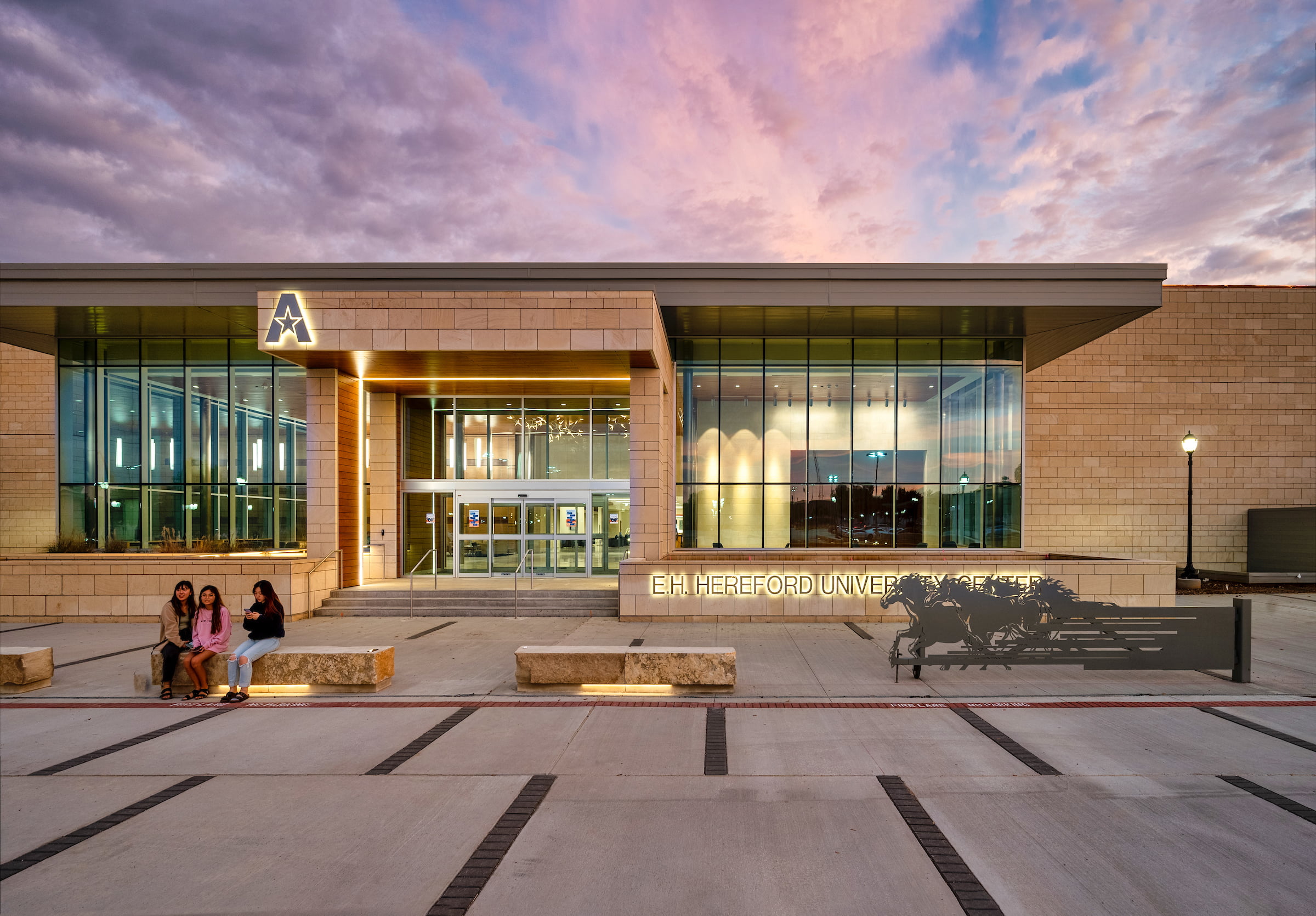 University of Texas at Arlington's University Center with a sunset in the background