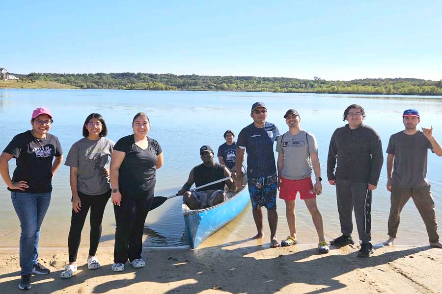 Students at a lake, some in a canoe