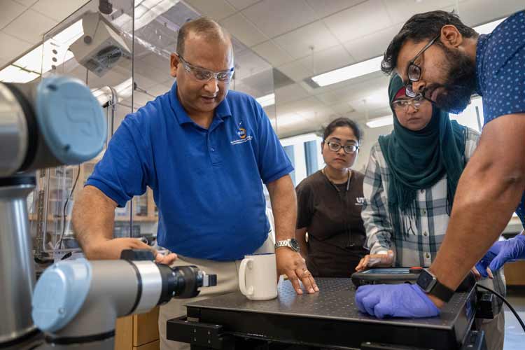Doctoral student Braxton Smith explains his thesis in a lab at Nedderman Hall.