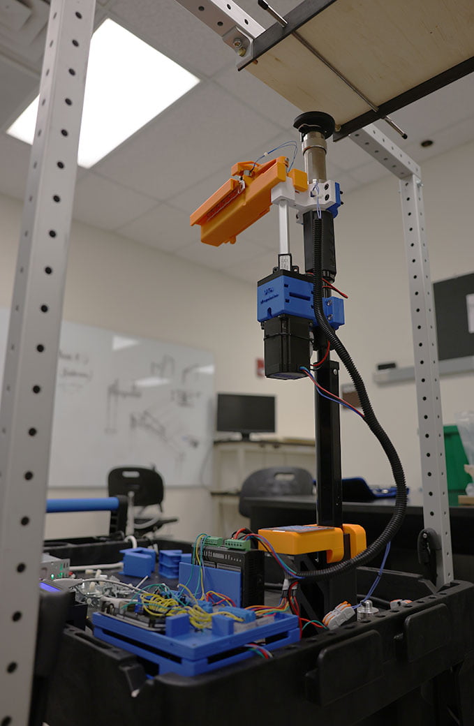 Senior design project, a machine that rests on an automated cart and moves back and forth to attach fasteners to a roof