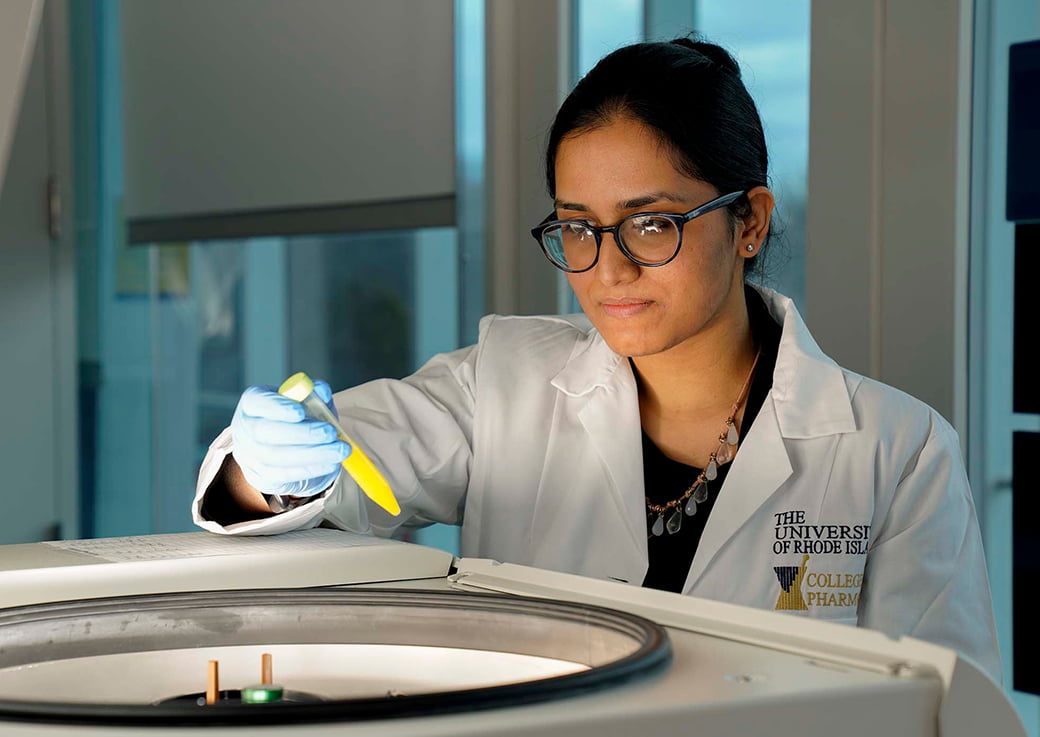 Jyoshi Menon stands in front of a medical engineering device