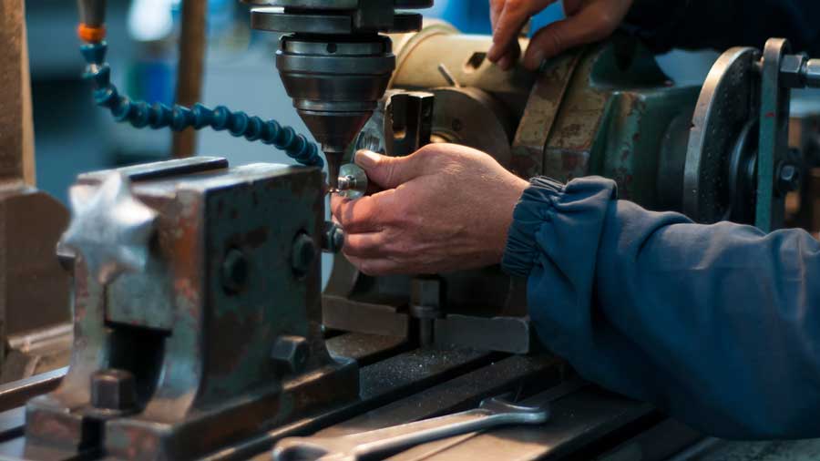 Worker at a metal working machine